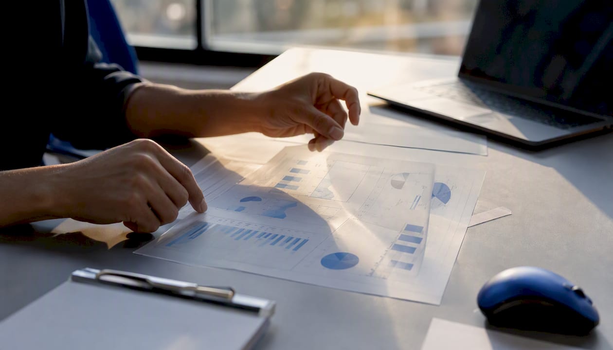 Hands arranging transparent data charts