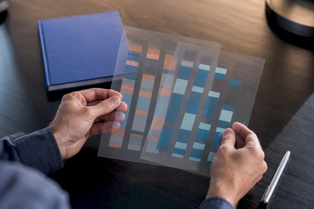 Hands comparing data sampling frame transparencies