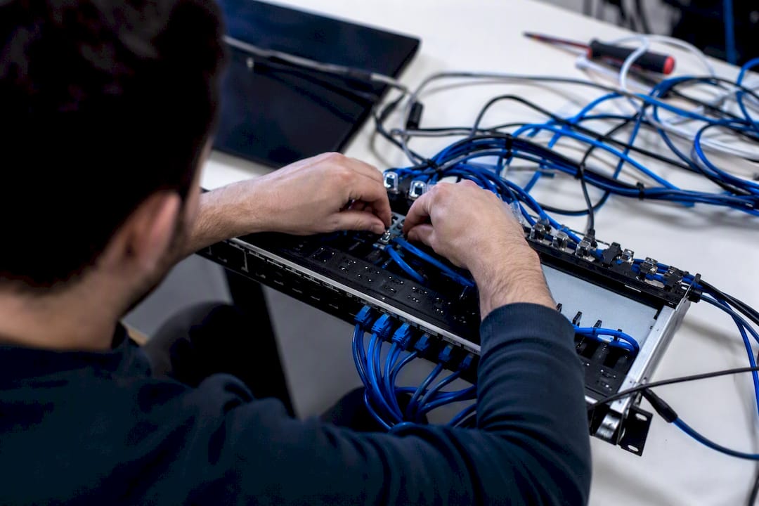 Hands adjusting server patch cables